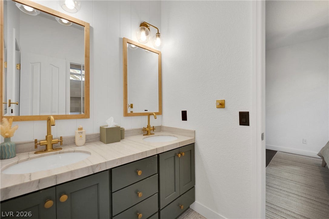 2516 Serenity Hollow Drive, Henderson, NV 89052 Jack & Jill Bathroom featuring a spacious Dual Vanity with stylish gold hardware.