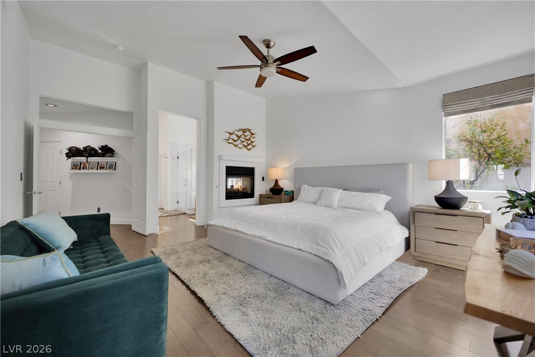 2516 Serenity Hollow Drive, Henderson, NV 89052 An inviting primary suite features rich hardwood flooring, a cozy fireplace, and access to an outdoor Pool/Spa for morning coffee.