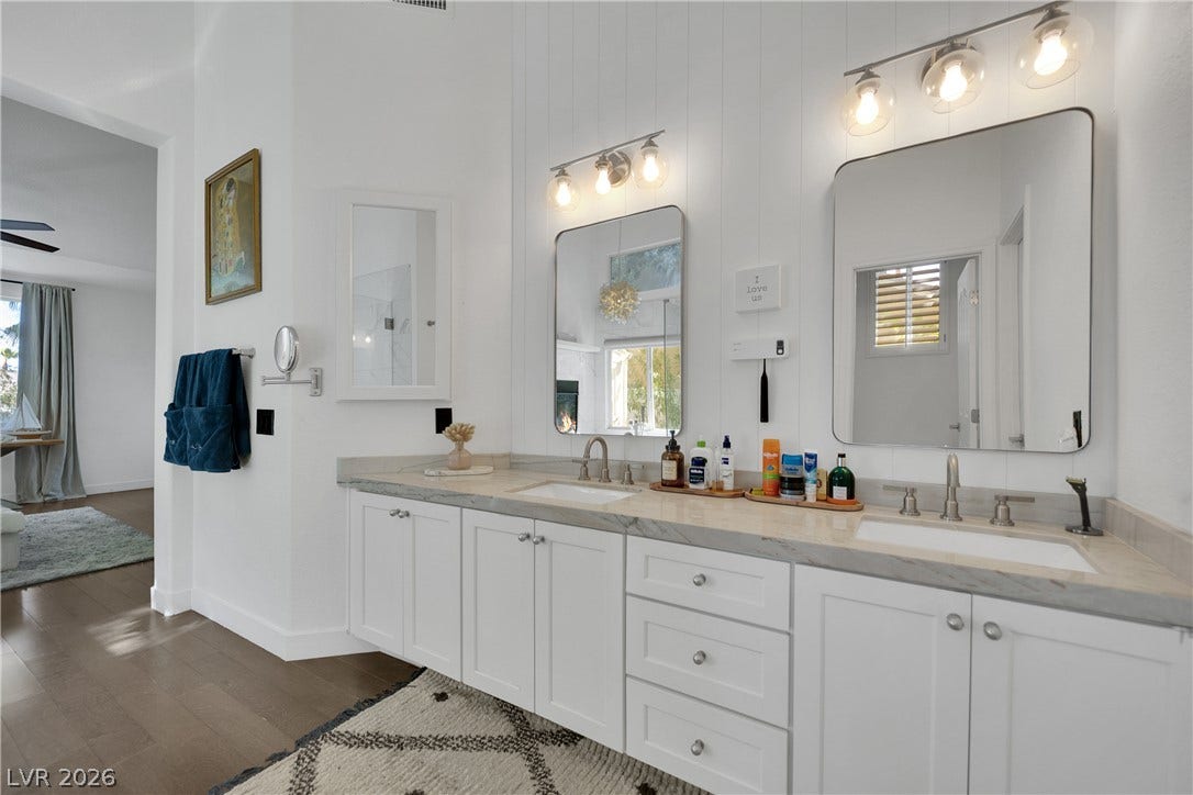 2516 Serenity Hollow Drive, Henderson, NV 89052 Dual Sinks set in white cabinetry with polished stone countertops.