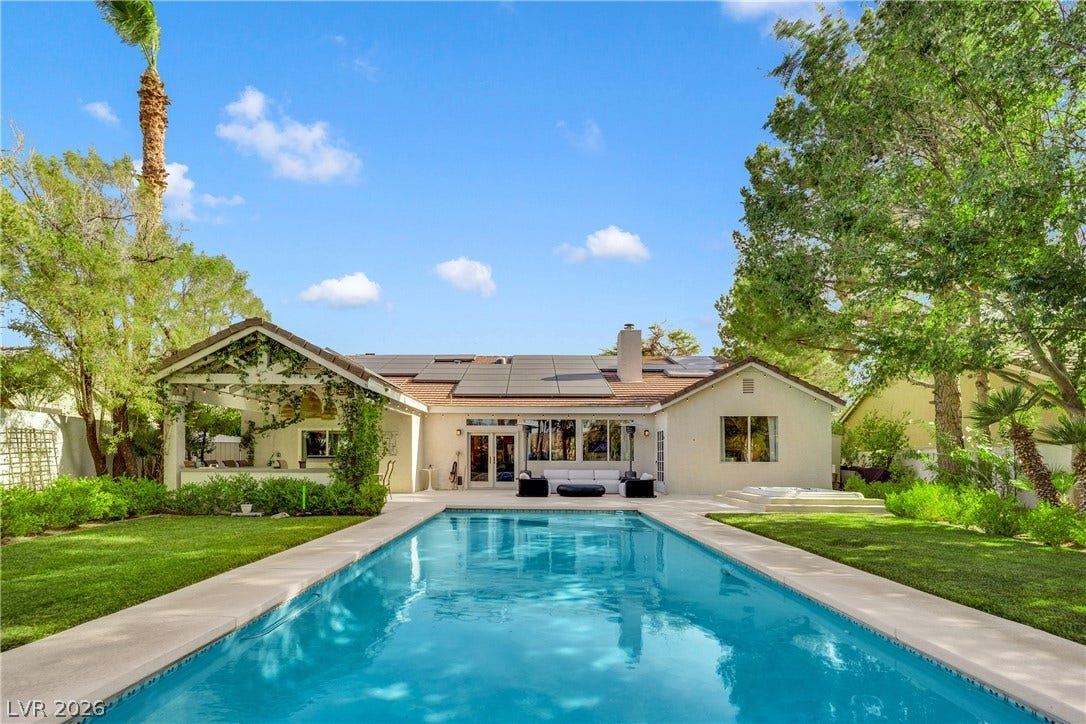 2516 Serenity Hollow Drive, Henderson, NV 89052 Heated Saltwater Pool , surrounded by lush landscaping and mature palm trees.