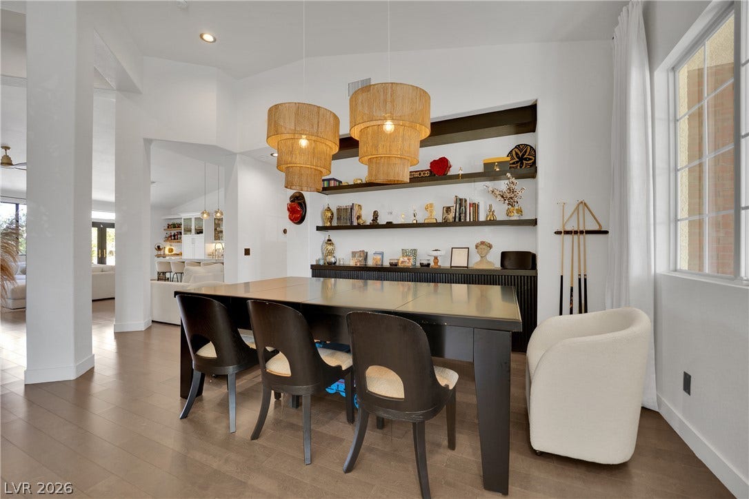 2516 Serenity Hollow Drive, Henderson, NV 89052 Custom lighting and built-in shelving elevate this dining /entertainment area.