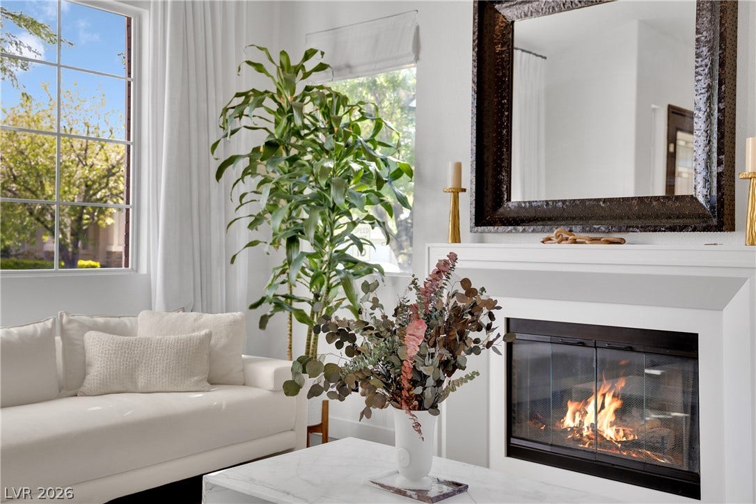 2516 Serenity Hollow Drive, Henderson, NV 89052 A well-lit living space, featuring a cozy fireplace for relaxed gatherings.