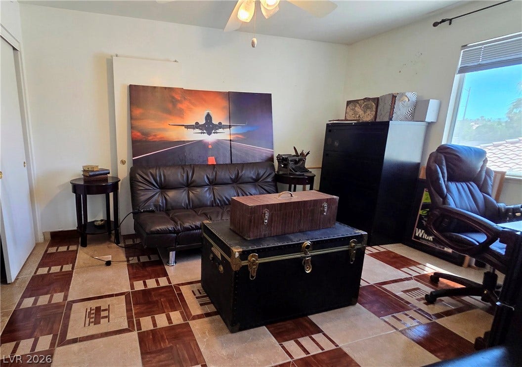 884 E Robindale Road, Las Vegas, NV 89123 A well-lit room featuring a distinctive patterned tile floor and a spacious window for natural illumination.