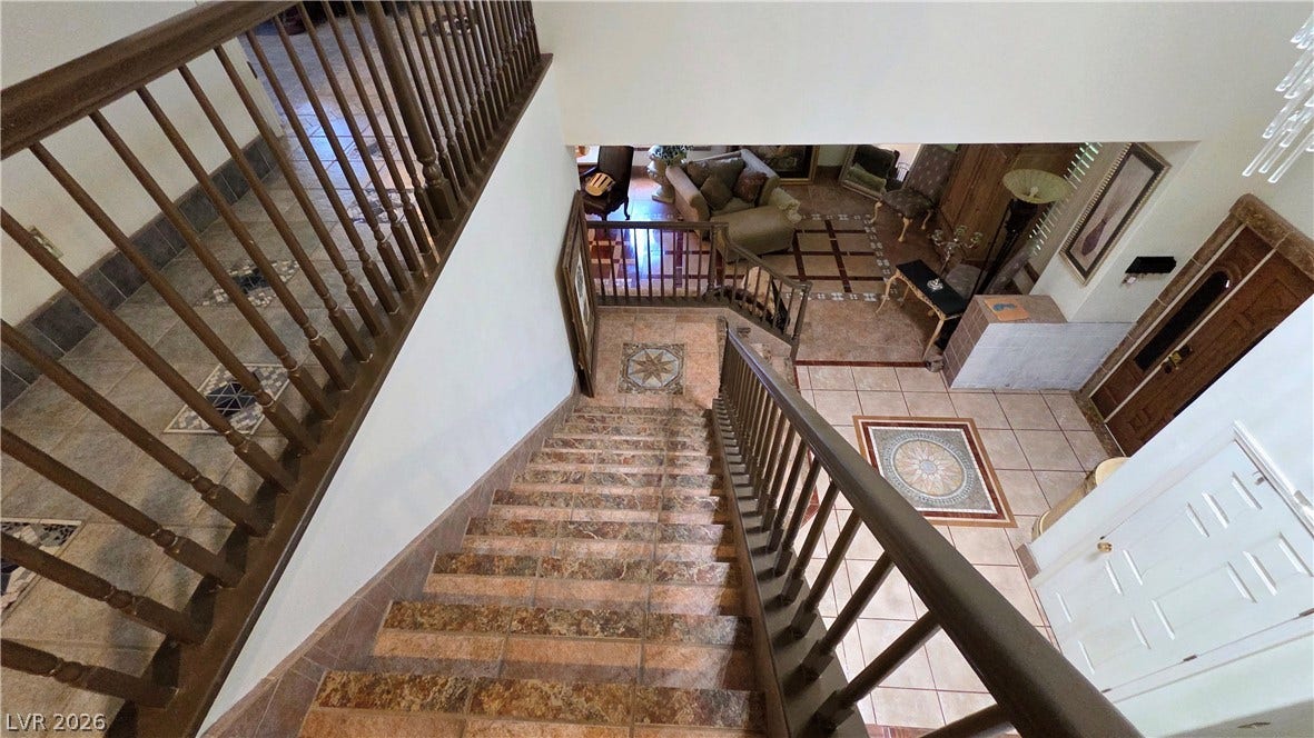 884 E Robindale Road, Las Vegas, NV 89123 Ornate tiled stairs lead to a spacious foyer with inlaid floor patterns.