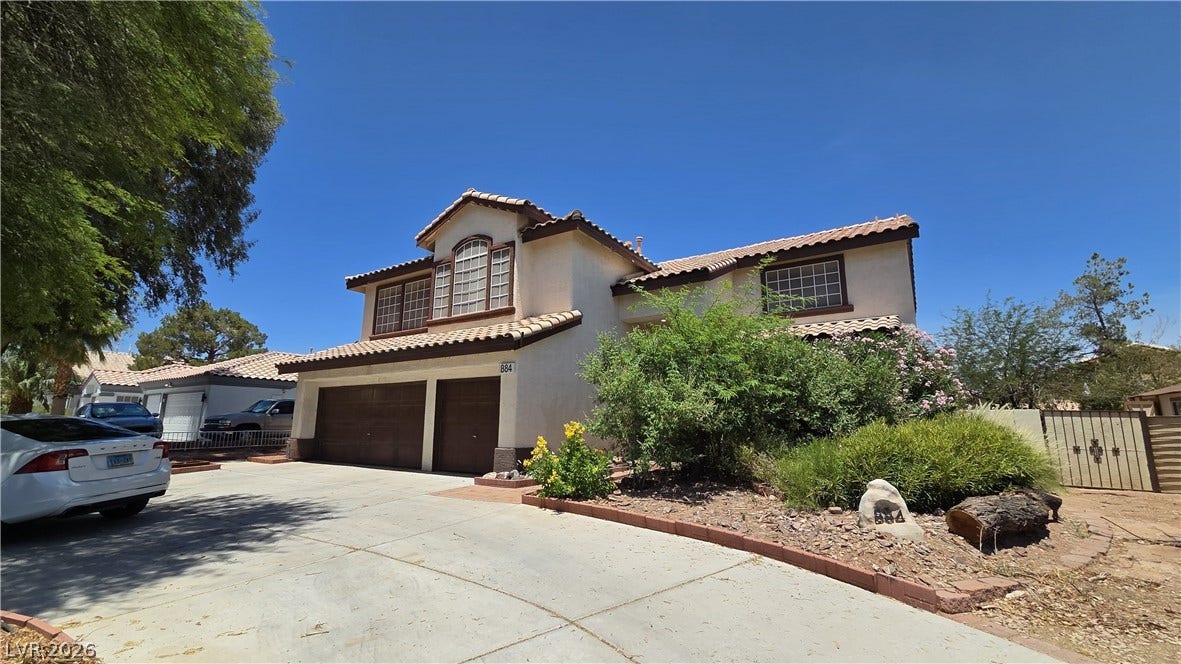 884 E Robindale Road, Las Vegas, NV 89123 A terracotta-tiled roof crowns this residence with an integrated three-car garage, RV parking space and drought-tolerant landscaping.