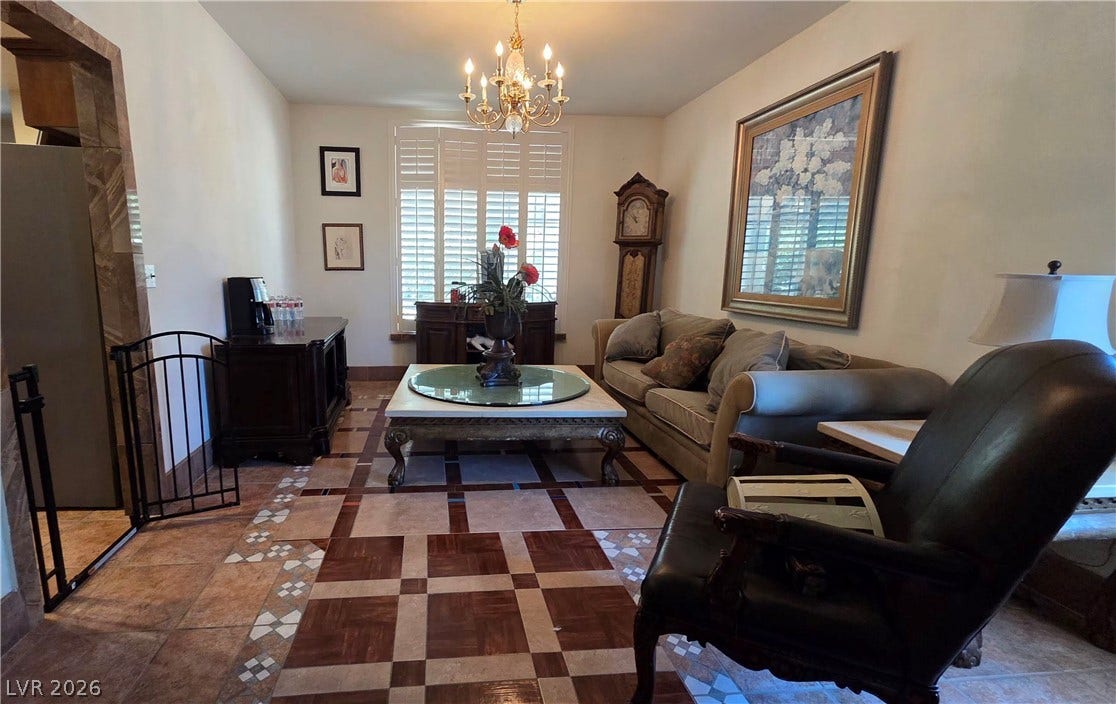 884 E Robindale Road, Las Vegas, NV 89123 Ornate tiled flooring and an elegant chandelier elevate this refined living room.