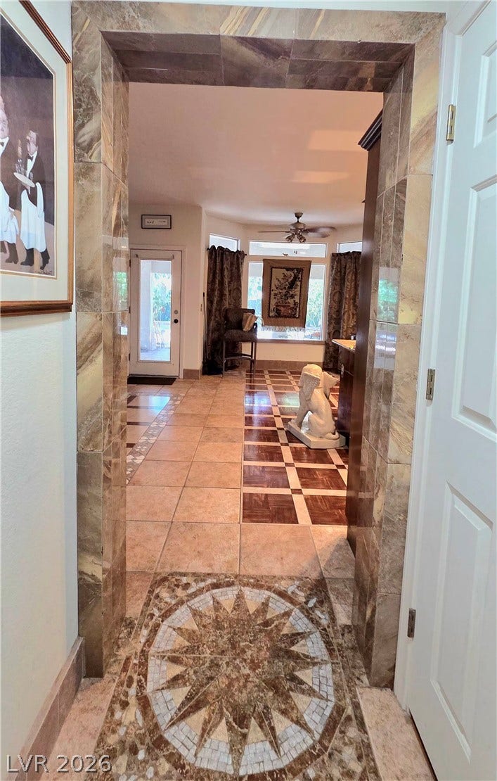 884 E Robindale Road, Las Vegas, NV 89123 A grand tiled archway with a captivating floor medallion welcomes guests into this elegant space.
