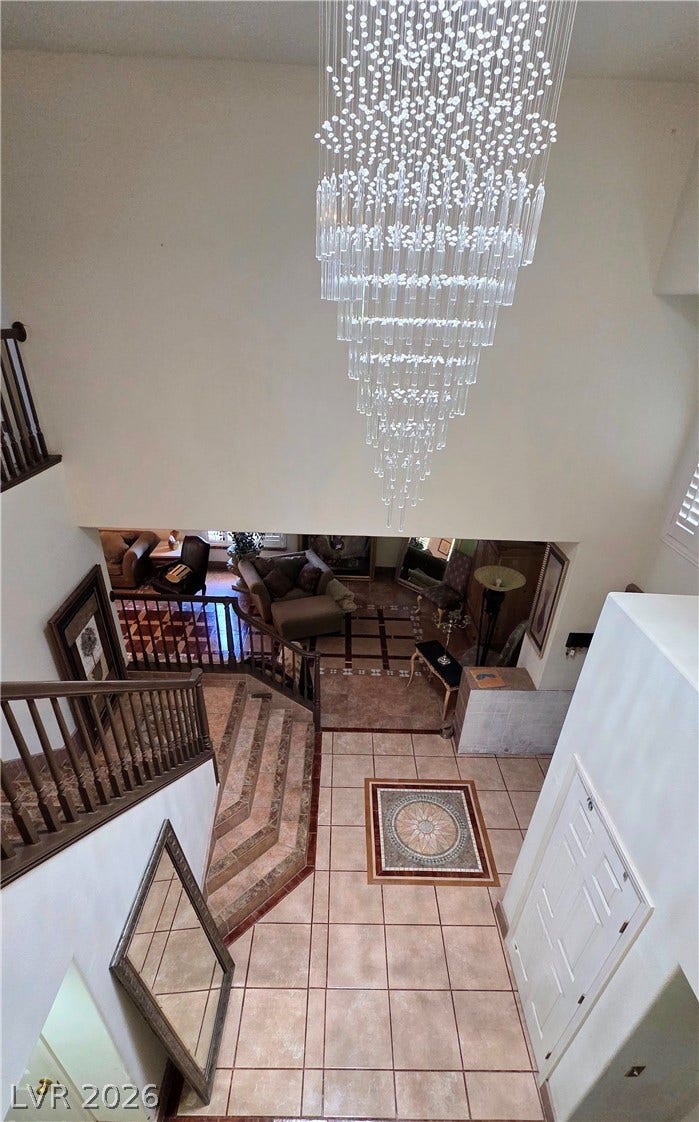 884 E Robindale Road, Las Vegas, NV 89123 A grand, multi-level entry foyer boasts a stunning chandelier and intricate tilework.