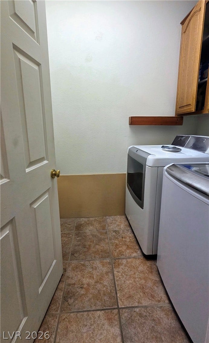 884 E Robindale Road, Las Vegas, NV 89123 Functional laundry space featuring modern appliances and a tiled floor for practicality.