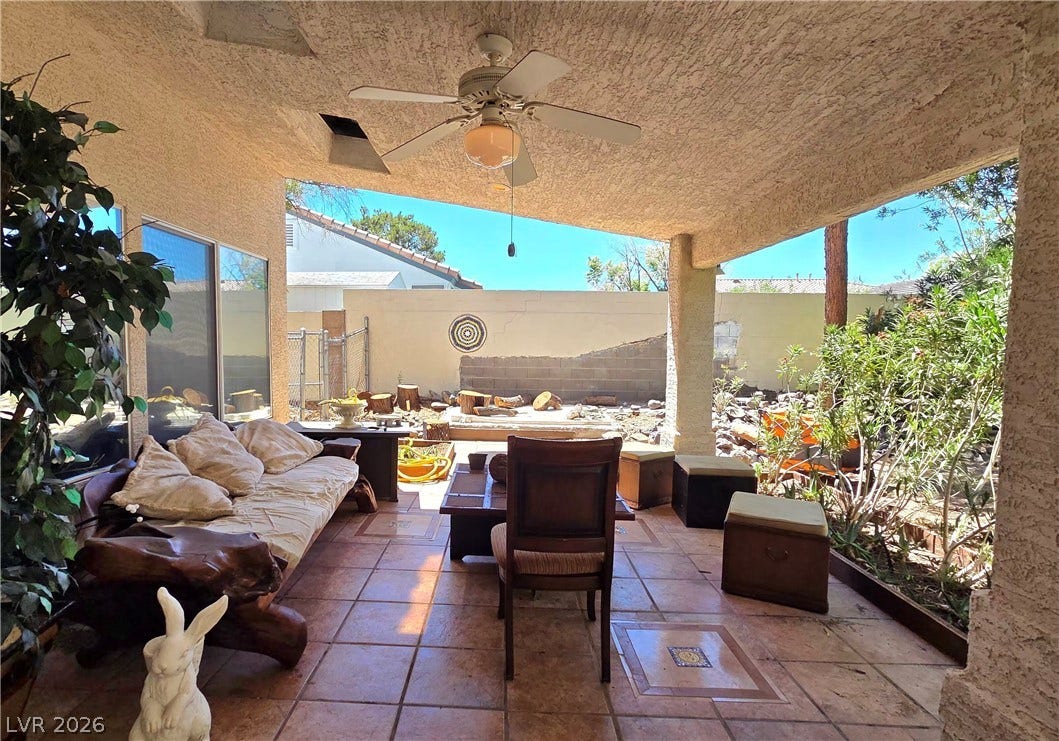 884 E Robindale Road, Las Vegas, NV 89123 An inviting covered patio featuring tiled flooring provides a comfortable outdoor living space.