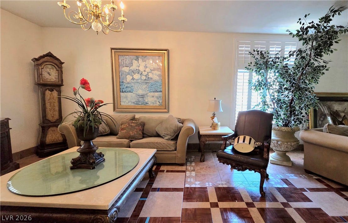 884 E Robindale Road, Las Vegas, NV 89123 Ornate flooring and a grand chandelier define this welcoming living space.