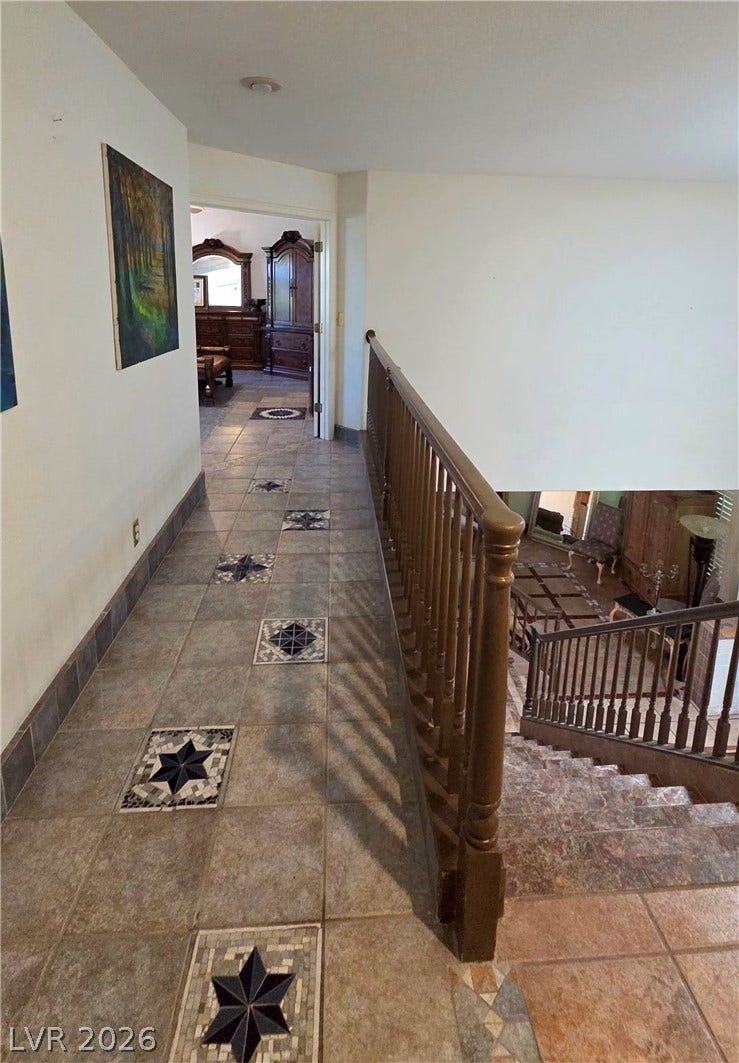 884 E Robindale Road, Las Vegas, NV 89123 Ornate tiled flooring accents a spacious hallway, leading to a gracefully descending staircase.