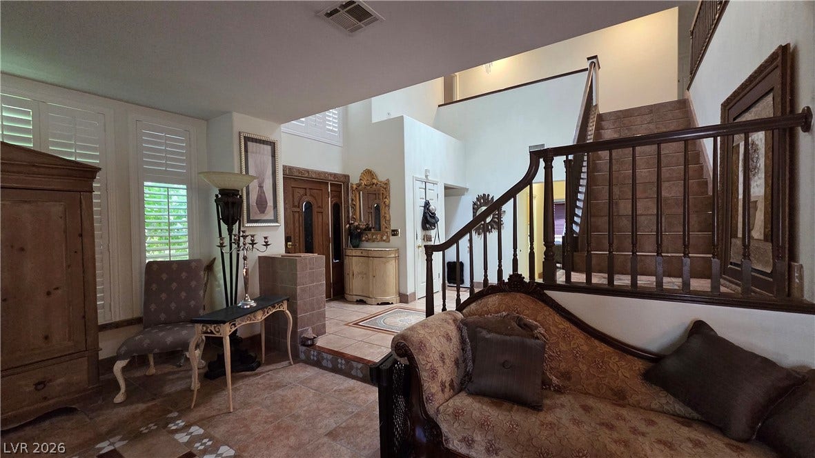 884 E Robindale Road, Las Vegas, NV 89123 Grand entryway featuring a tiled staircase, soaring ceilings, and a well-lit landing.