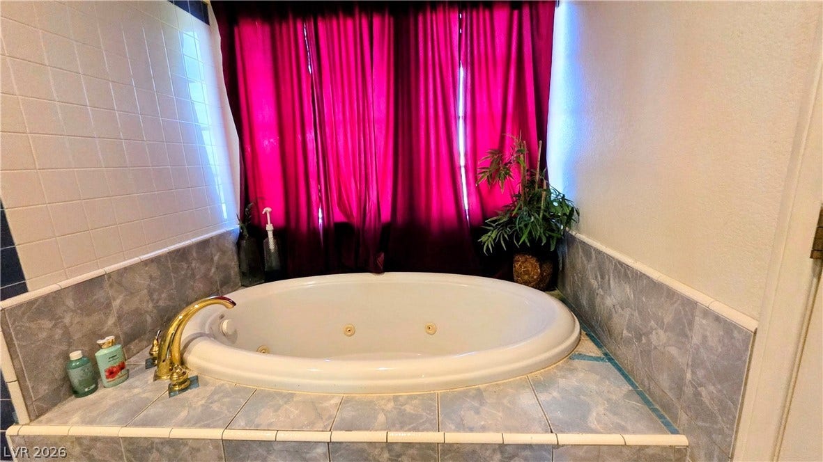 884 E Robindale Road, Las Vegas, NV 89123 Indulge in a relaxing soak within this inviting jetted tub, a luxurious retreat.