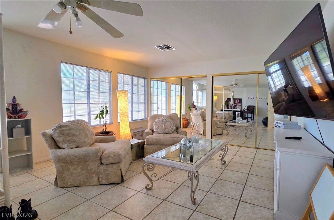 884 E Robindale Road, Las Vegas, NV 89123 Natural light cascades through multiple windows, illuminating this inviting living space.