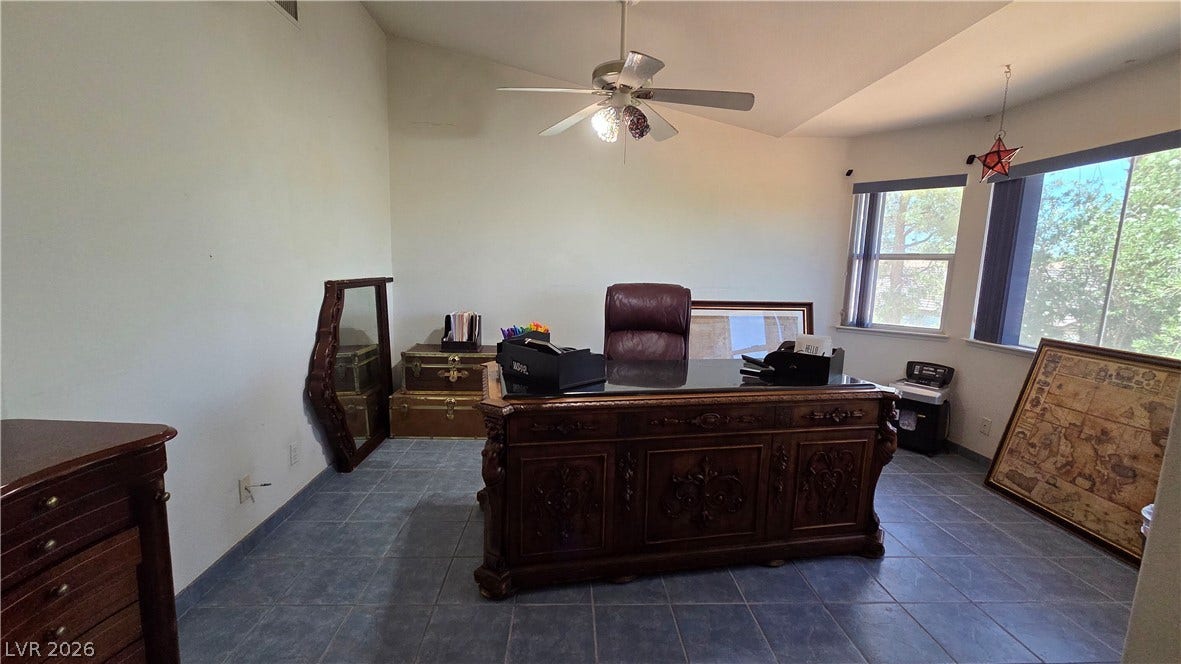 884 E Robindale Road, Las Vegas, NV 89123 A well-lit study with vaulted ceilings, featuring large windows and durable tile flooring.