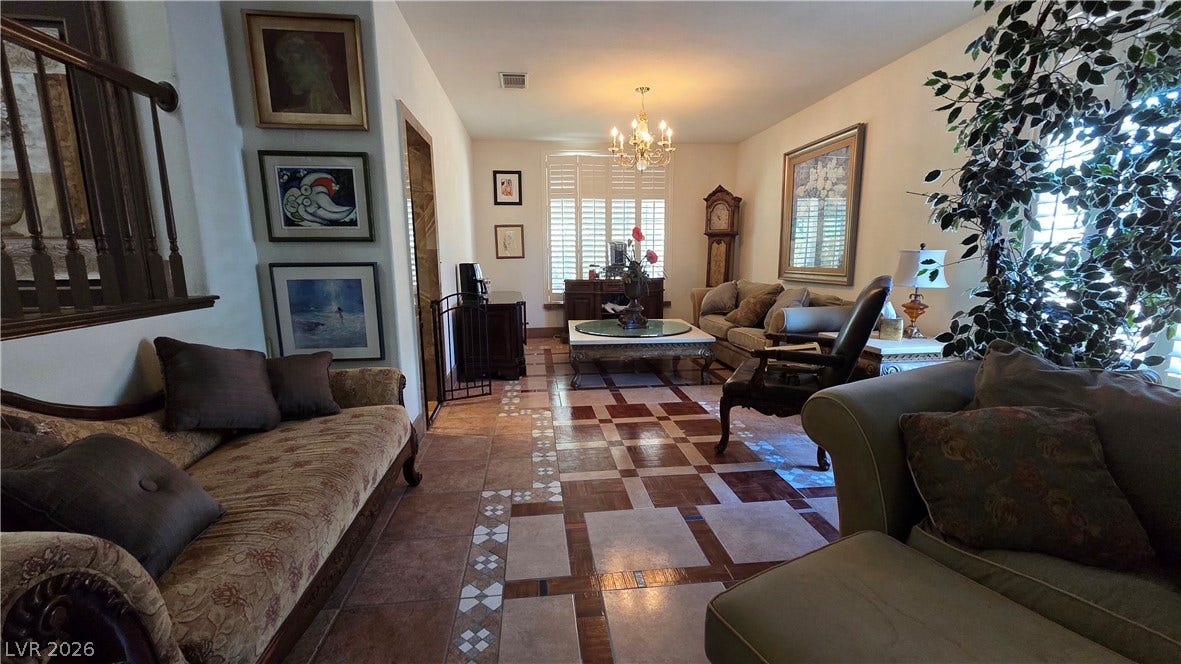 884 E Robindale Road, Las Vegas, NV 89123 Ornate tiled flooring flows throughout this comfortable living space, bathed in natural illumination from the window.
