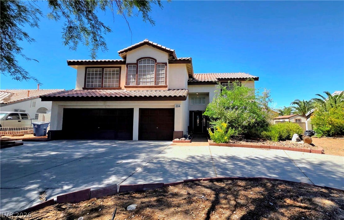 884 E Robindale Road, Las Vegas, NV 89123 A spacious home with a two-car garage offers an inviting presence and ample parking.