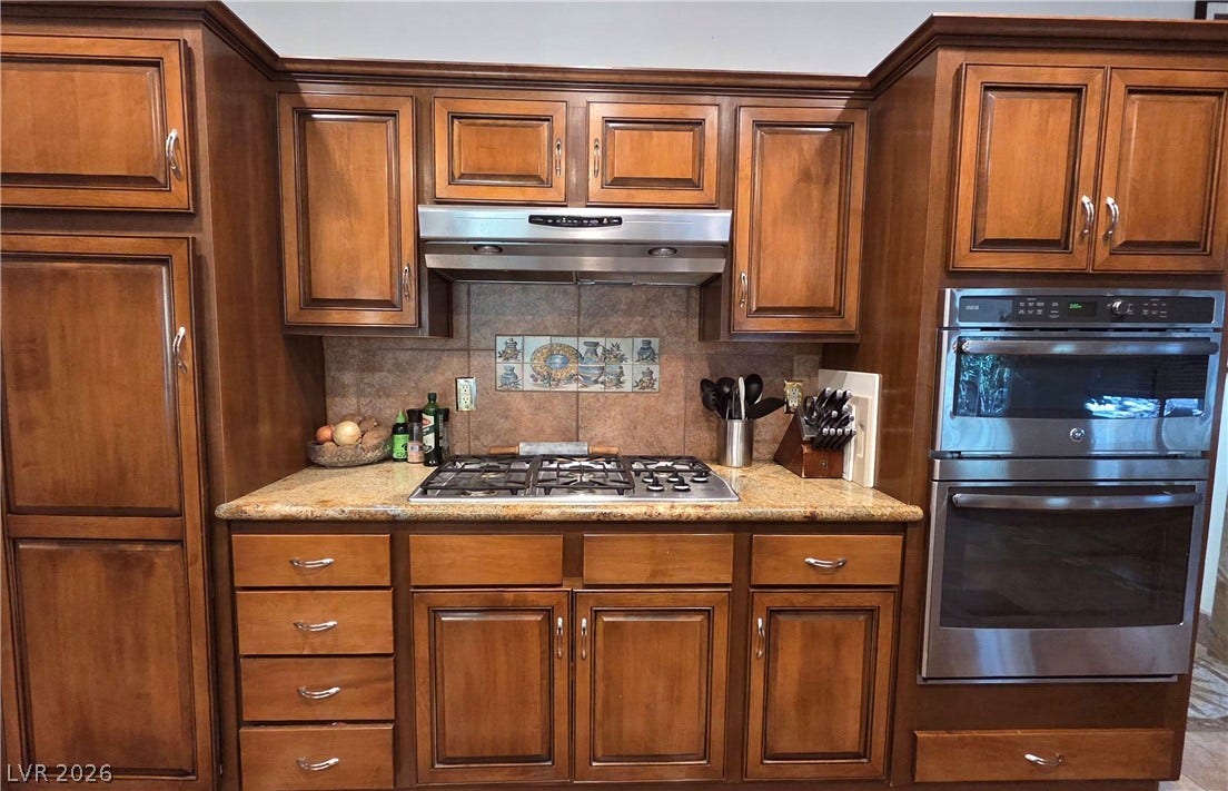 884 E Robindale Road, Las Vegas, NV 89123 Culinary delights await with a built-in gas range, stainless steel appliances, and ample cabinet storage.