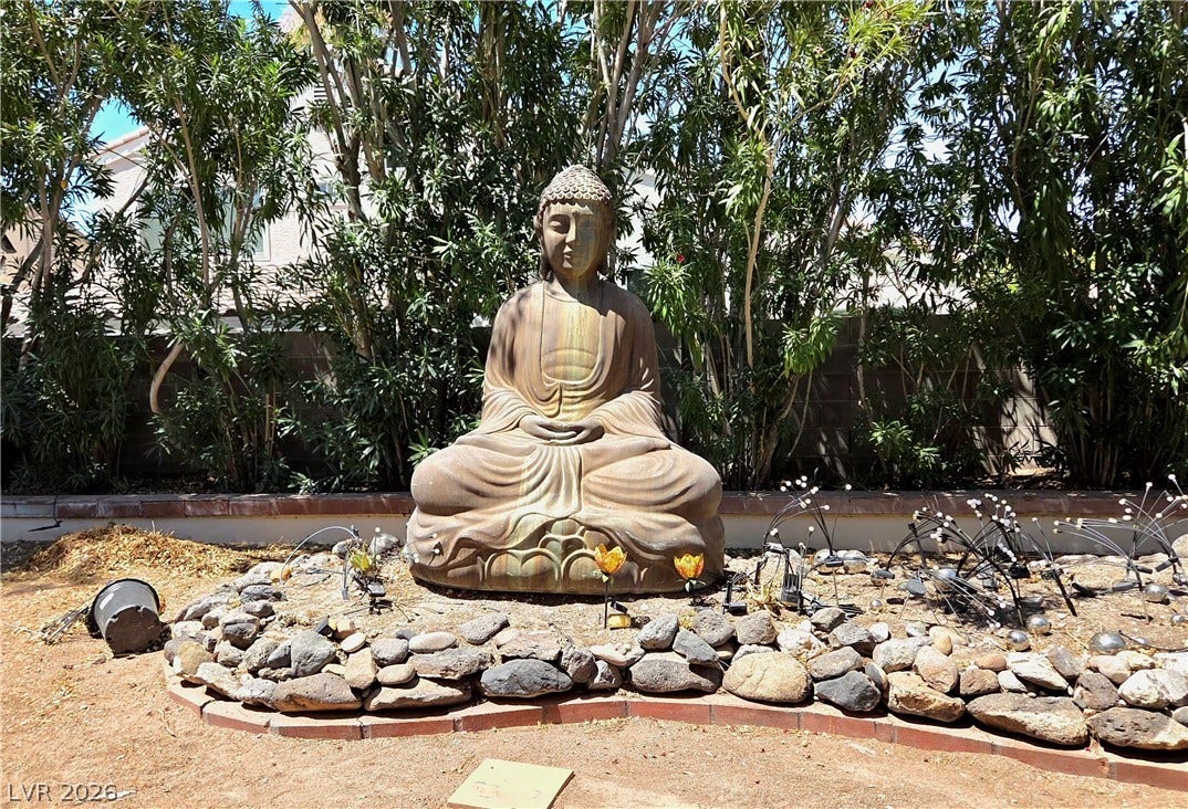 884 E Robindale Road, Las Vegas, NV 89123 A tranquil garden sanctuary offers a peaceful outdoor escape. Buddha is not included in the sale of the house.