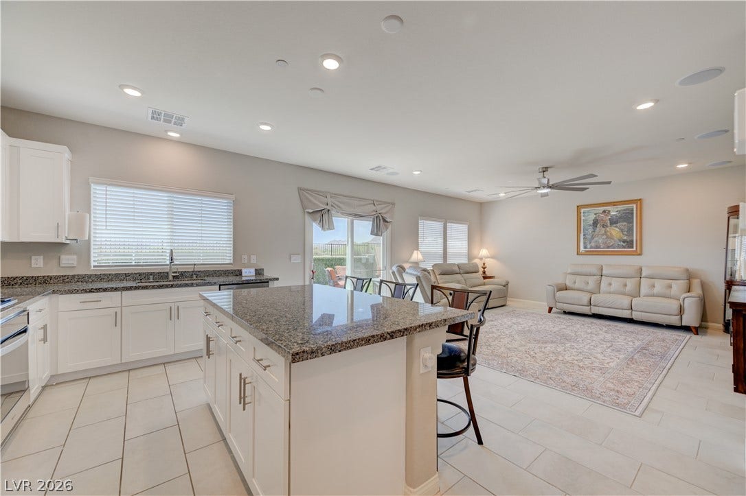 A chef's kitchen with granite counters opens into an inviting living area, perfect for entertaining.