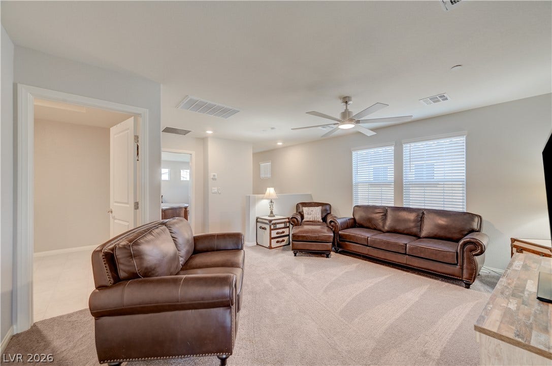 An inviting versatile loft could be secondary living space with ceiling fan & light adds to the homes appeal, providing an ideal area for relaxation or play.