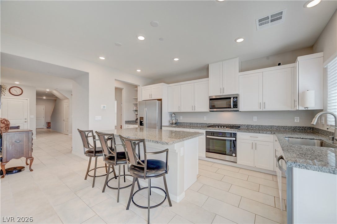 Kitchen features island w/breakfast bar, granite counters, white shaker cabinets w/soft close cabinets & drawers, ceramic tile floors, butlers pantry, Stainless Steel appliances to include refrigerator, dishwasher, gas cooktop, built in oven & microwave, ceramic tile floors, dining nook as well as separate formal dining area and recessed lights.
