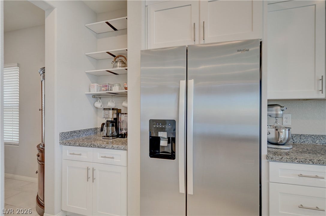 Functional kitchen with ample cabinet space, granite countertops, and stainless steel appliances.