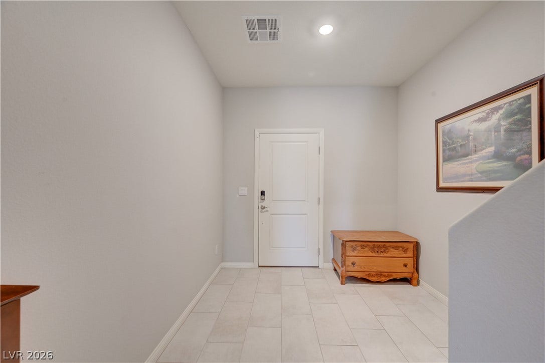 A well-lit entry with sleek tile flooring and ample space welcomes all who enter.