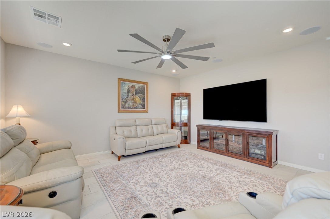 Natural light illuminates this spacious living area with outdoor access and contemporary tile flooring with oversized ceiling fan & light, ceramic tile floors & two tone paint and surround sound with speakers that flows seamlessly into the kitchen and dining area