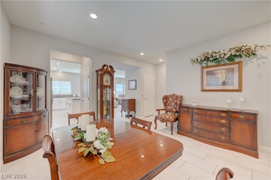 Recessed lighting illuminates this inviting formal dining area, flowing seamlessly into the kitchen.