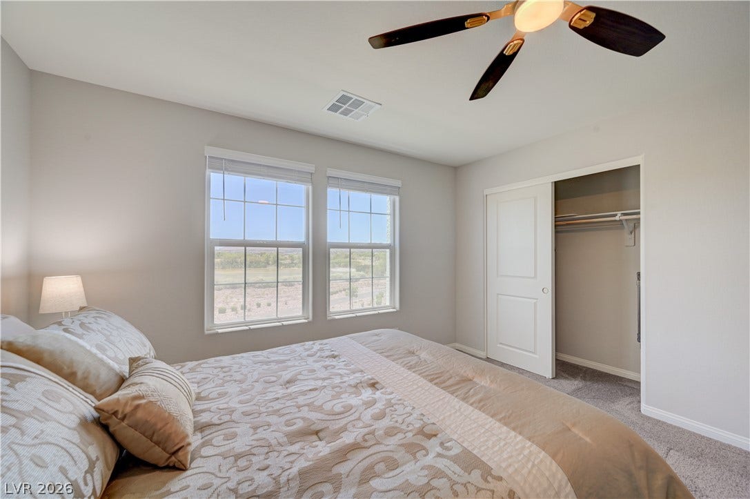 Natural light floods this inviting 2nd bedroom, highlighting a practical closet and comfortable carpeting.