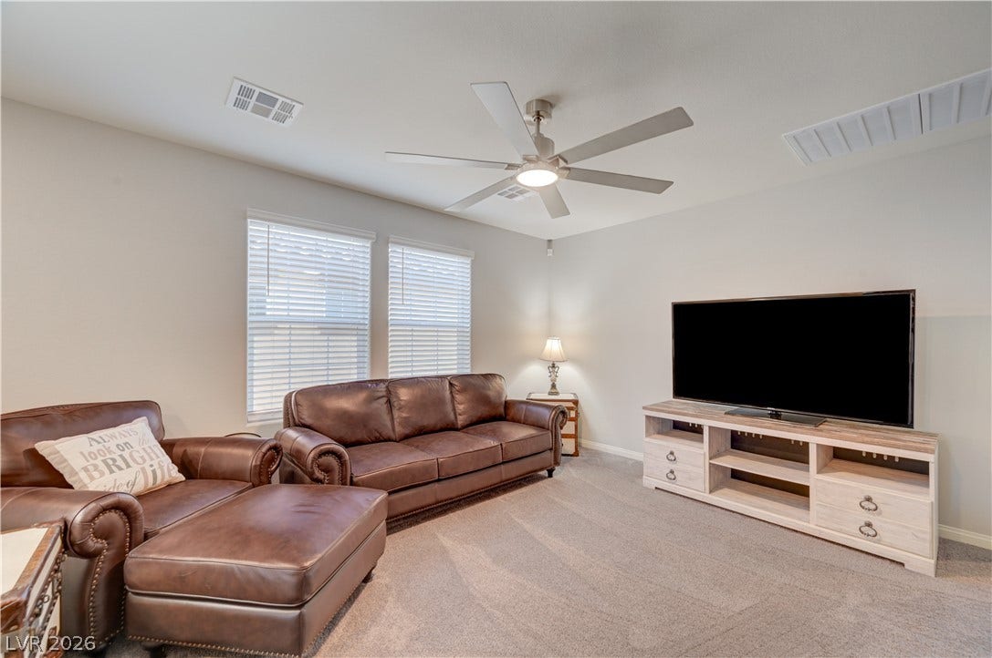 An inviting versatile loft could be secondary living space with ceiling fan & light adds to the homes appeal, providing an ideal area for relaxation or play.