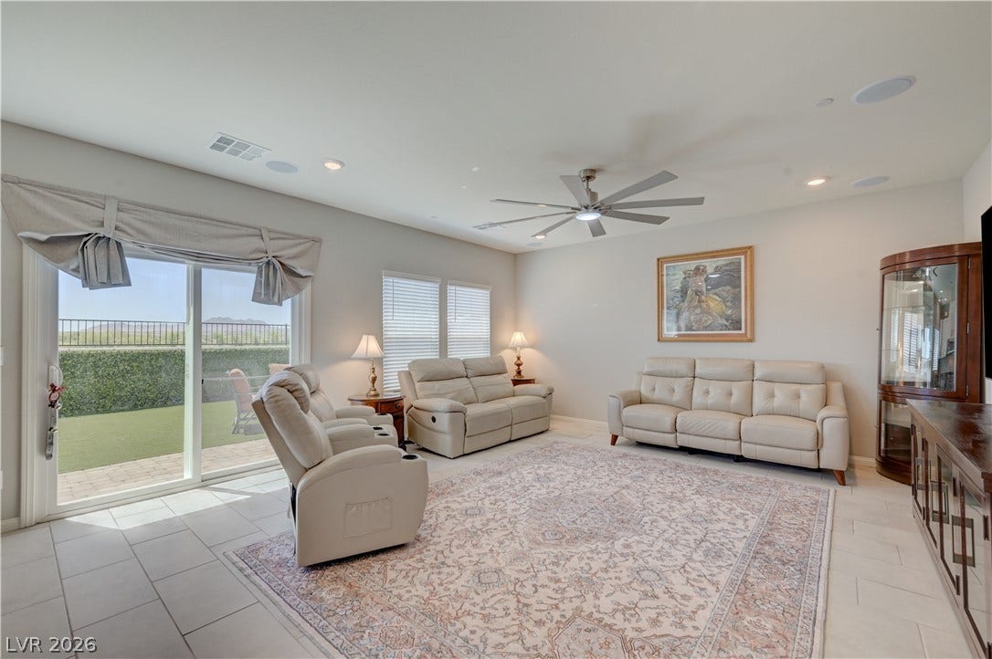 Natural light illuminates this spacious living area with outdoor access and contemporary tile flooring with oversized ceiling fan & light, ceramic tile floors & two tone paint and surround sound with speakers that flows seamlessly into the kitchen and dining area