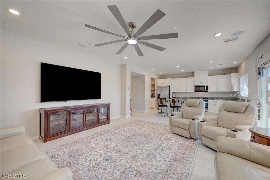 An open concept living area seamlessly flows into a kitchen, ideal for entertaining.