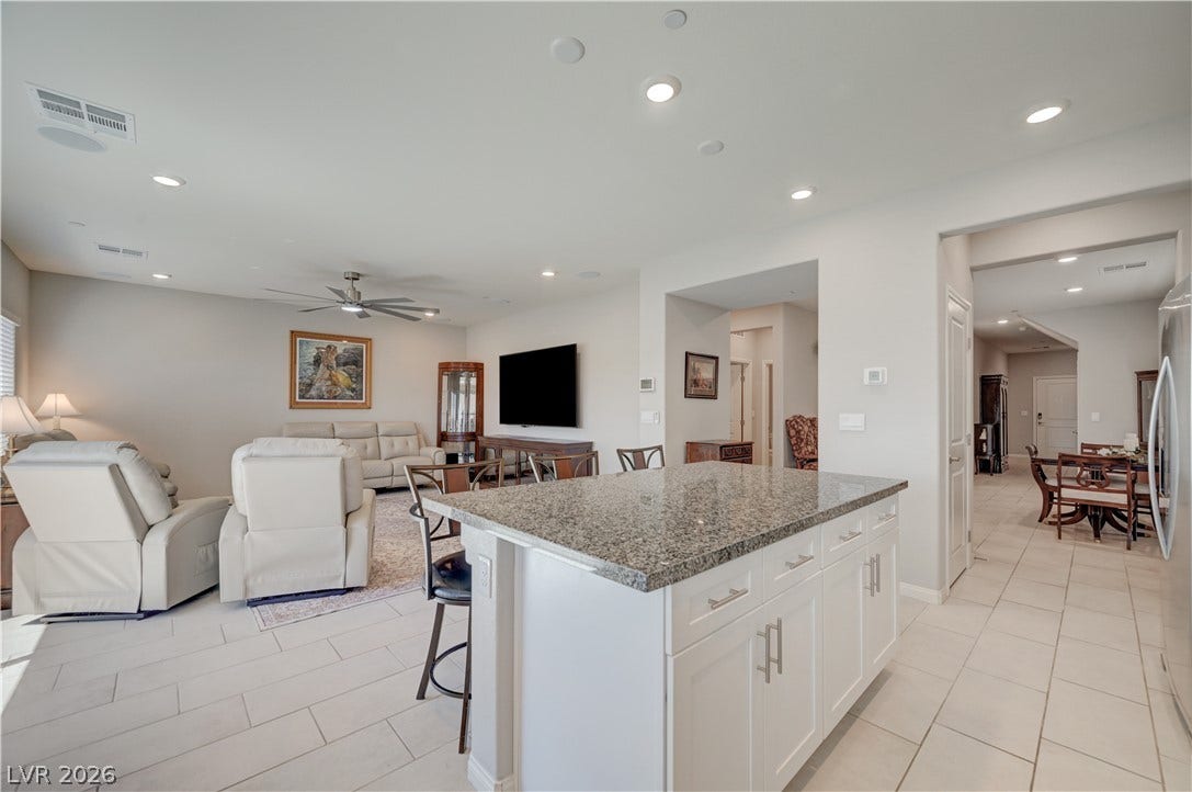 Kitchen features island w/breakfast bar, granite counters, white shaker cabinets w/soft close cabinets & drawers, ceramic tile floors, butlers pantry, Stainless Steel appliances to include refrigerator, dishwasher, gas cooktop, built in oven & microwave, ceramic tile floors, dining nook as well as separate formal dining area and recessed lights.