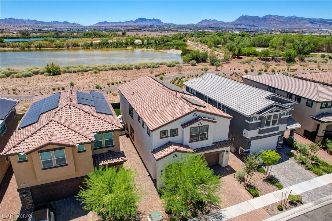 Discover picturesque mountain views behind the Henderson bird preserve from this contemporary home with solar panels.