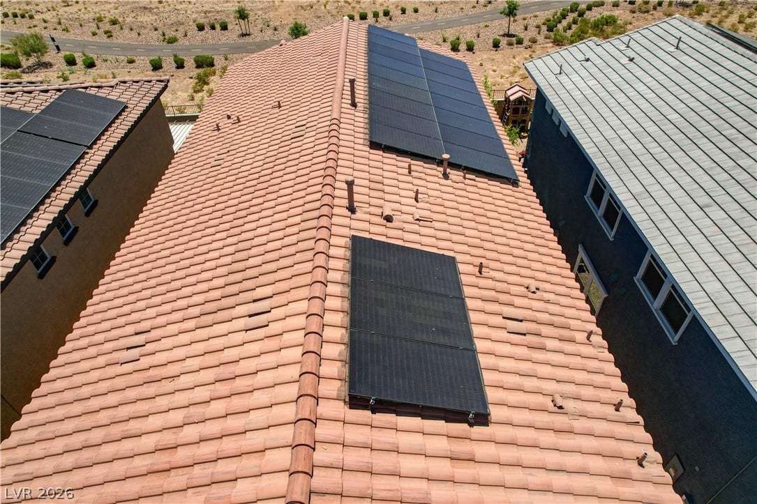 Solar panels integrate seamlessly on the classic tile roof of this energy-efficient home.