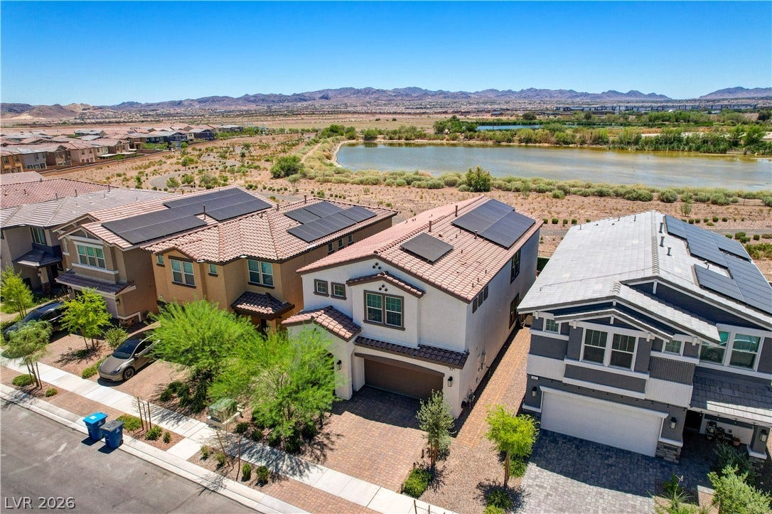 Overlooking a Henderson bird preserve striking curb appeal with modern solar-equipped rooftops.