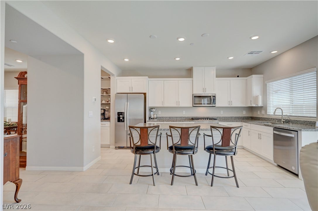 Kitchen features island w/breakfast bar, granite counters, white shaker cabinets w/soft close cabinets & drawers, ceramic tile floors, butlers pantry, Stainless Steel appliances to include refrigerator, dishwasher, gas cooktop, built in oven & microwave, ceramic tile floors, dining nook as well as separate formal dining area and recessed lights.