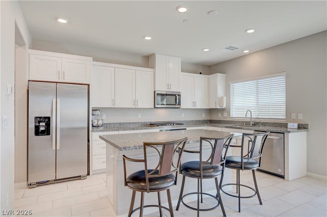 Kitchen features island w/breakfast bar, granite counters, white shaker cabinets w/soft close cabinets & drawers, ceramic tile floors, butlers pantry, Stainless Steel appliances to include refrigerator, dishwasher, gas cooktop, built in oven & microwave, ceramic tile floors, dining nook as well as separate formal dining area and recessed lights.