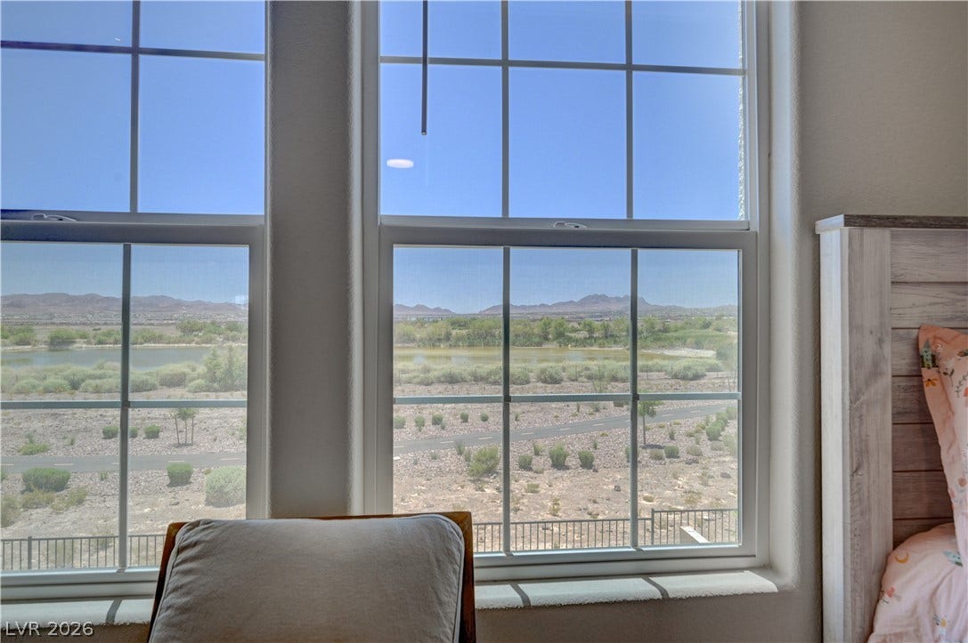 Capture the serene desert landscape and water feature through towering windows of the 3rd bedroom, inviting natural light.