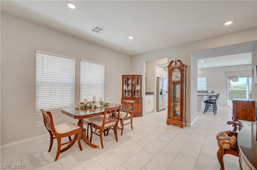 Clean lines and a spacious layout define this dining area, flowing seamlessly into the kitchen.