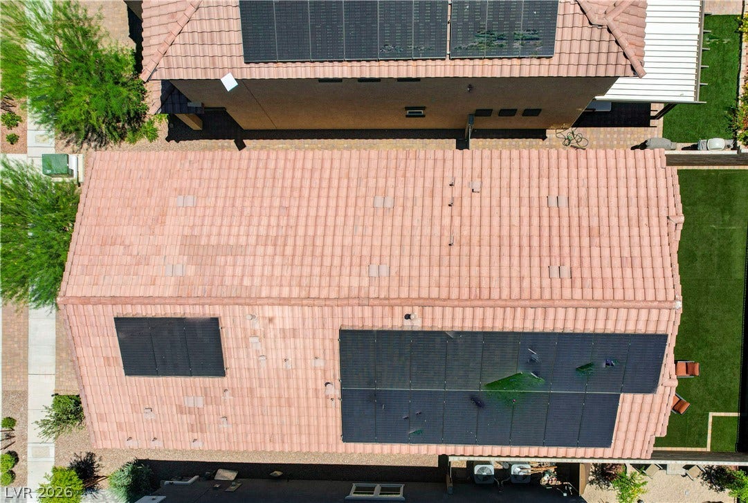 An aerial perspective showcases the tiled rooftops of a residential property, complete with solar panels for energy efficiency.