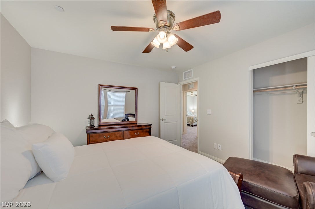 A comforting 4th bedroom space features a ceiling fan, plush carpeting, and a practical closet.
