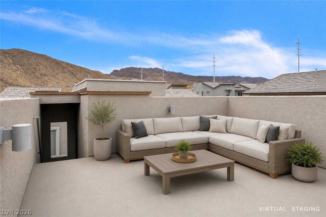 An inviting rooftop deck with comfortable seating offers impressive mountain views.
