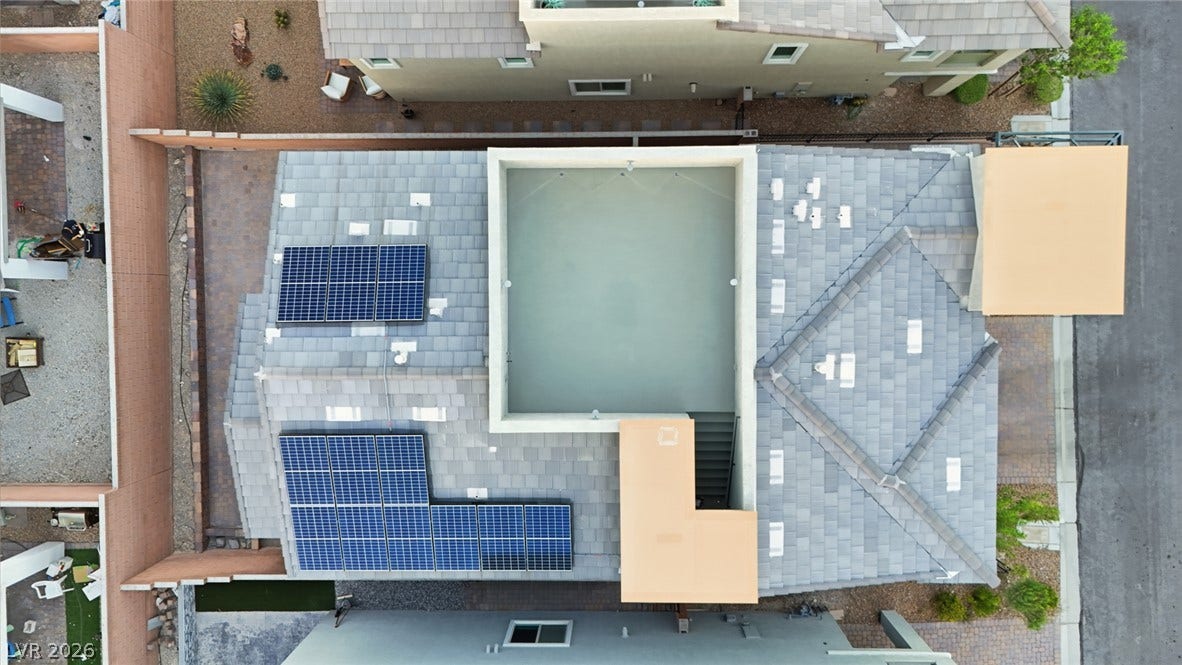 Solar panels integrate seamlessly onto the modern tile roof of this contemporary home.