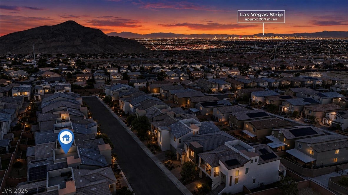 Distant city lights and rugged mountain silhouettes frame this twilight neighborhood panorama.