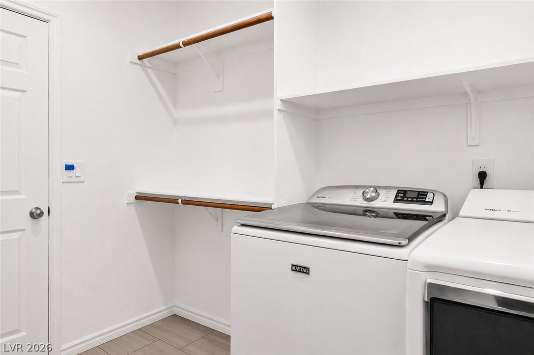 A well-appointed laundry area offers convenient clothing care with ample storage space and modern appliances.