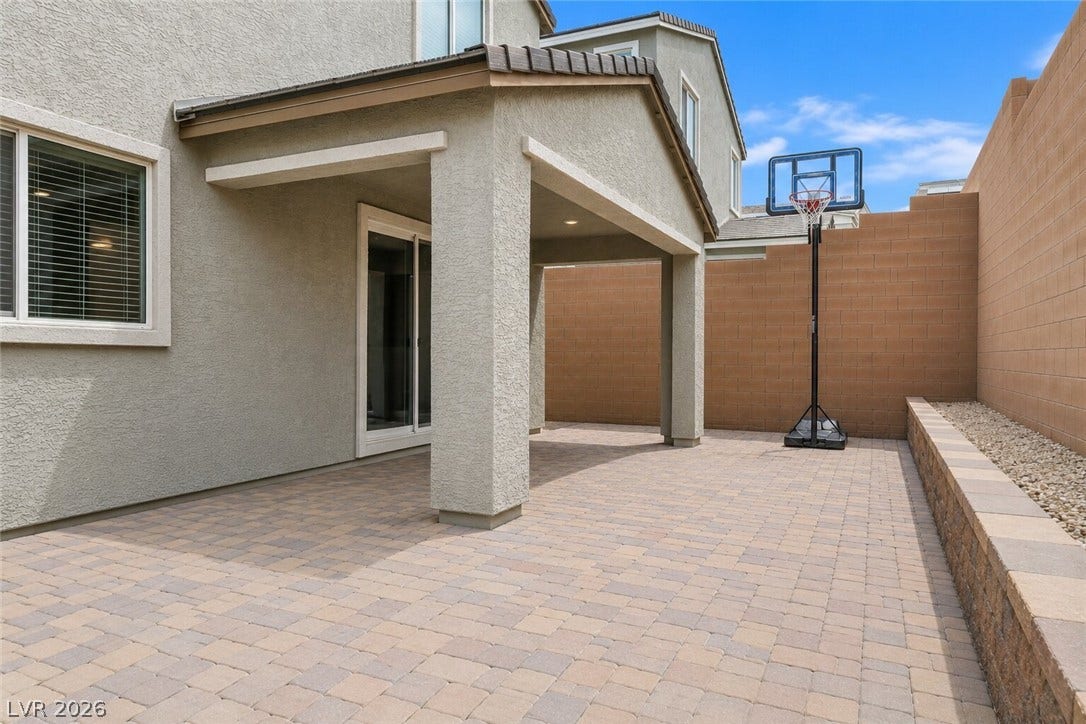 An inviting covered patio area offers a perfect spot for outdoor leisure and recreation.
